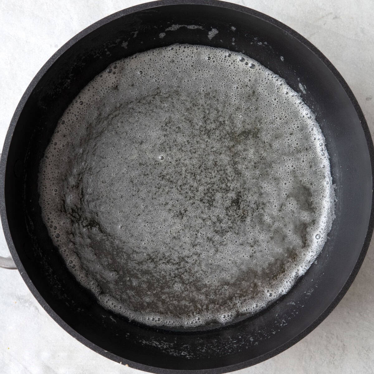 Melted butter in saucepan.