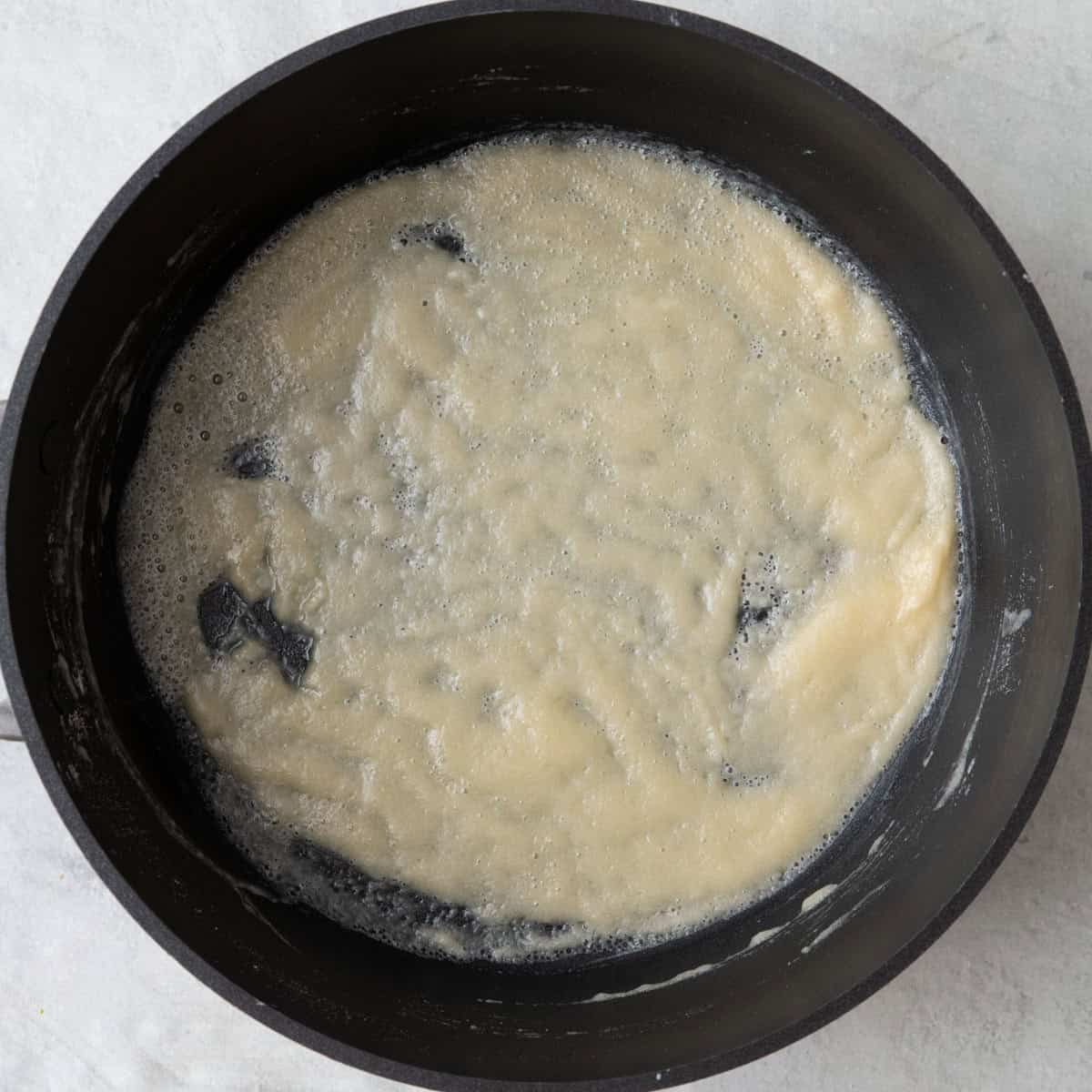 Butter and flour mixture after cooking, showing bubbly flour.