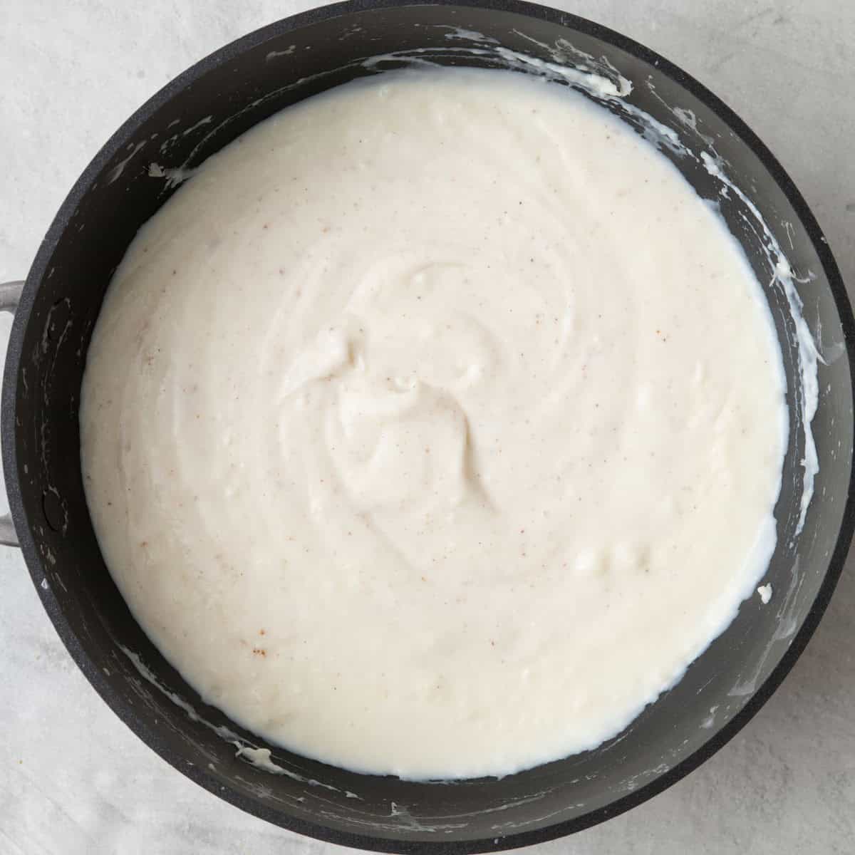 Final bechamel sauce in saucepan.
