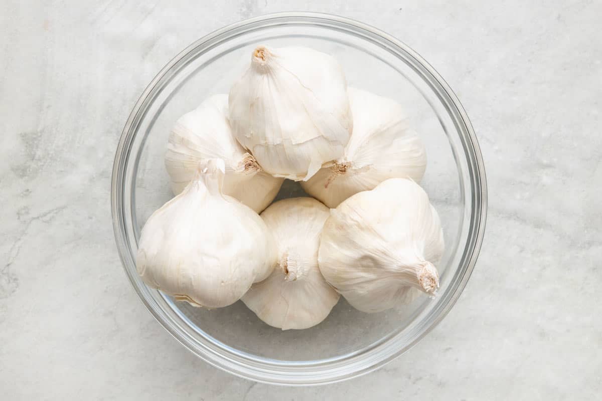 Bowl full of garlic heads.