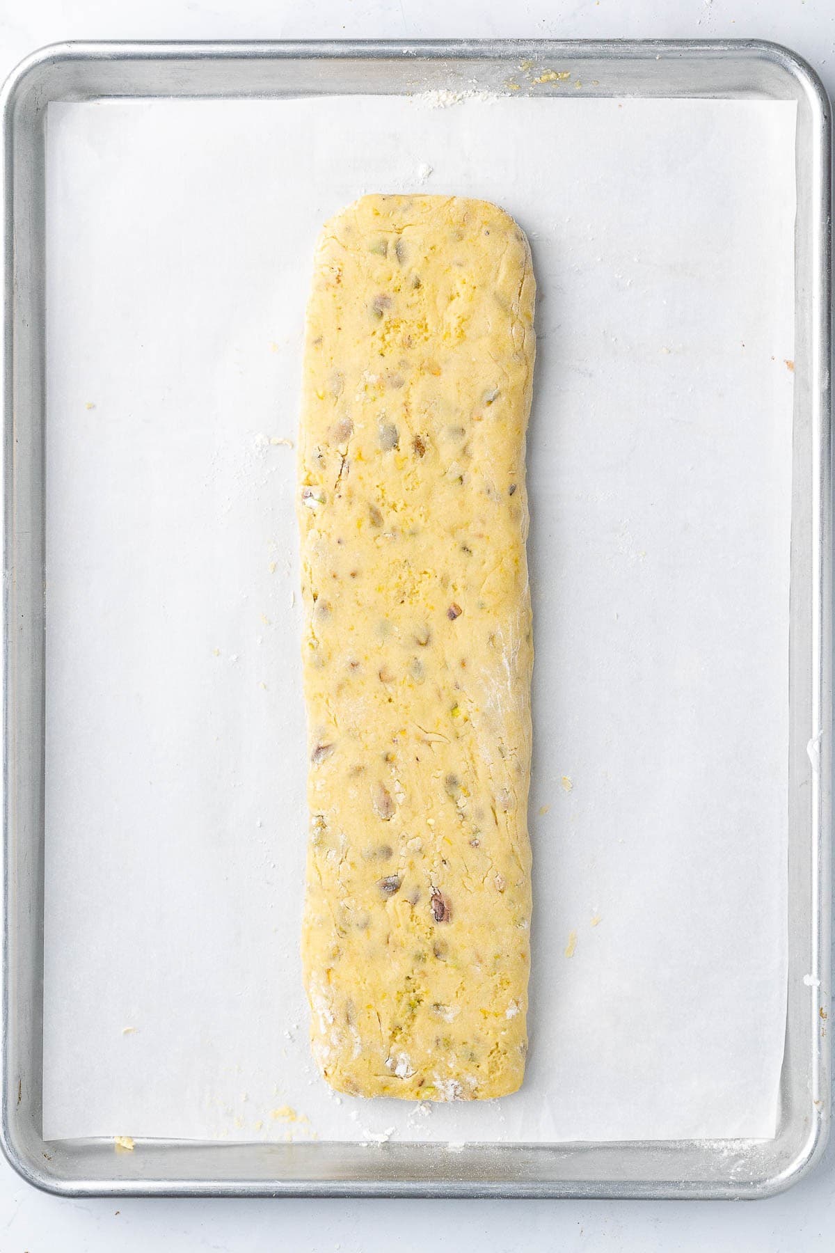 Kneaded dough shaped on parchment paper.