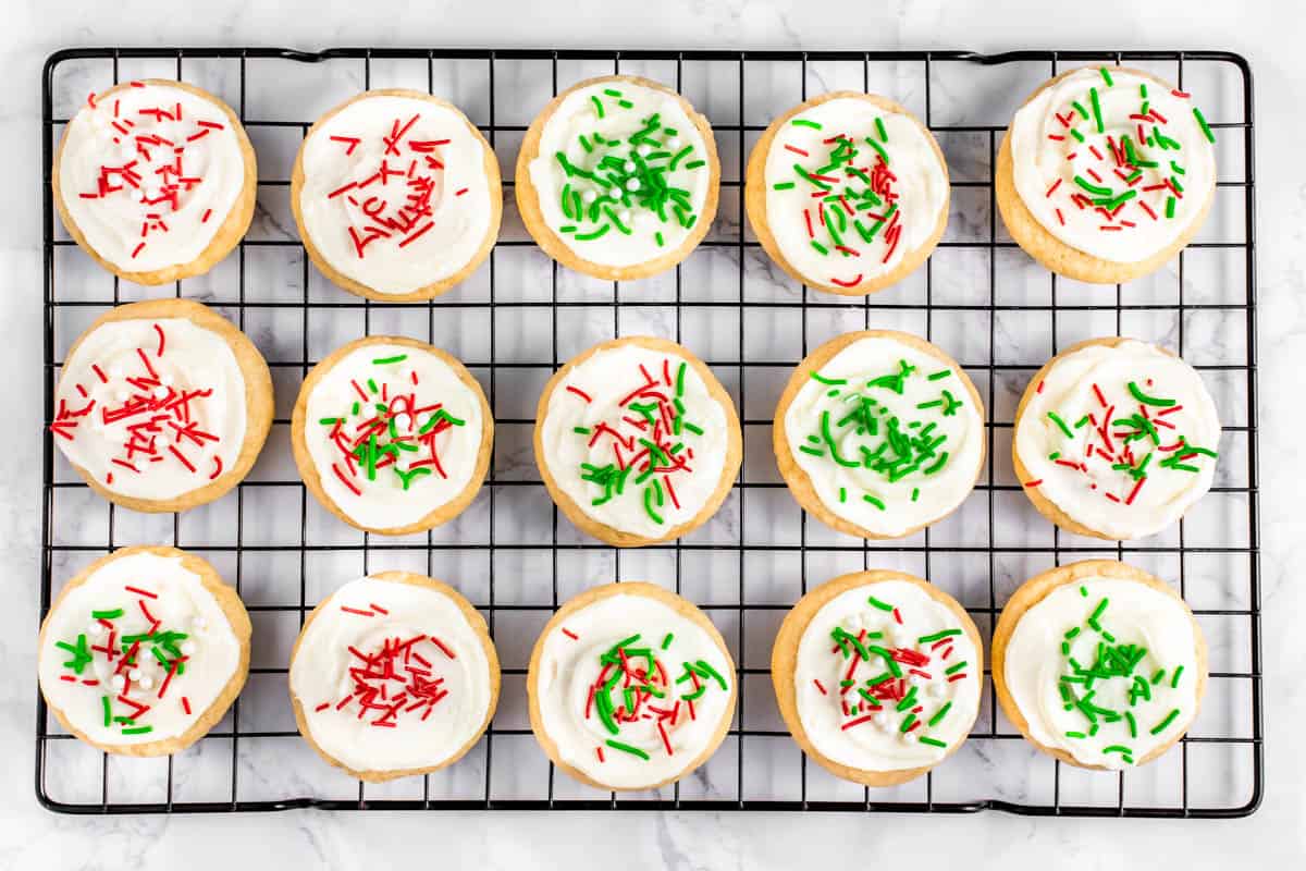 Soft baked Lofthouse cookies on a wire rack with green and red sprinkles.