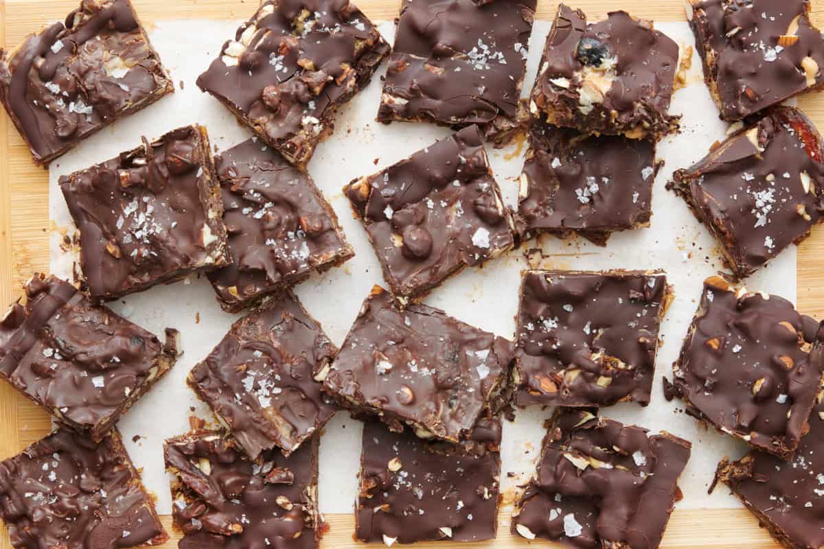 Date bark pieces in a bowl with tray of more nearby.