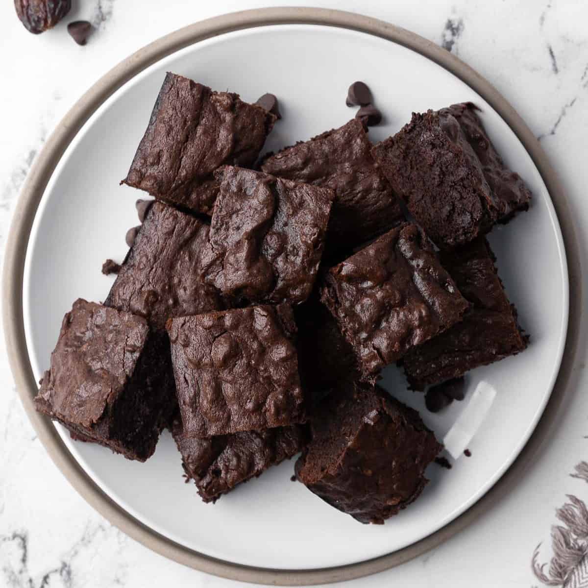 Date brownie squares on a round plate.