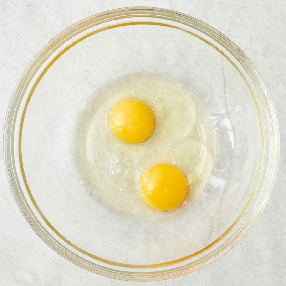 Eggs in a bowl before whisking.