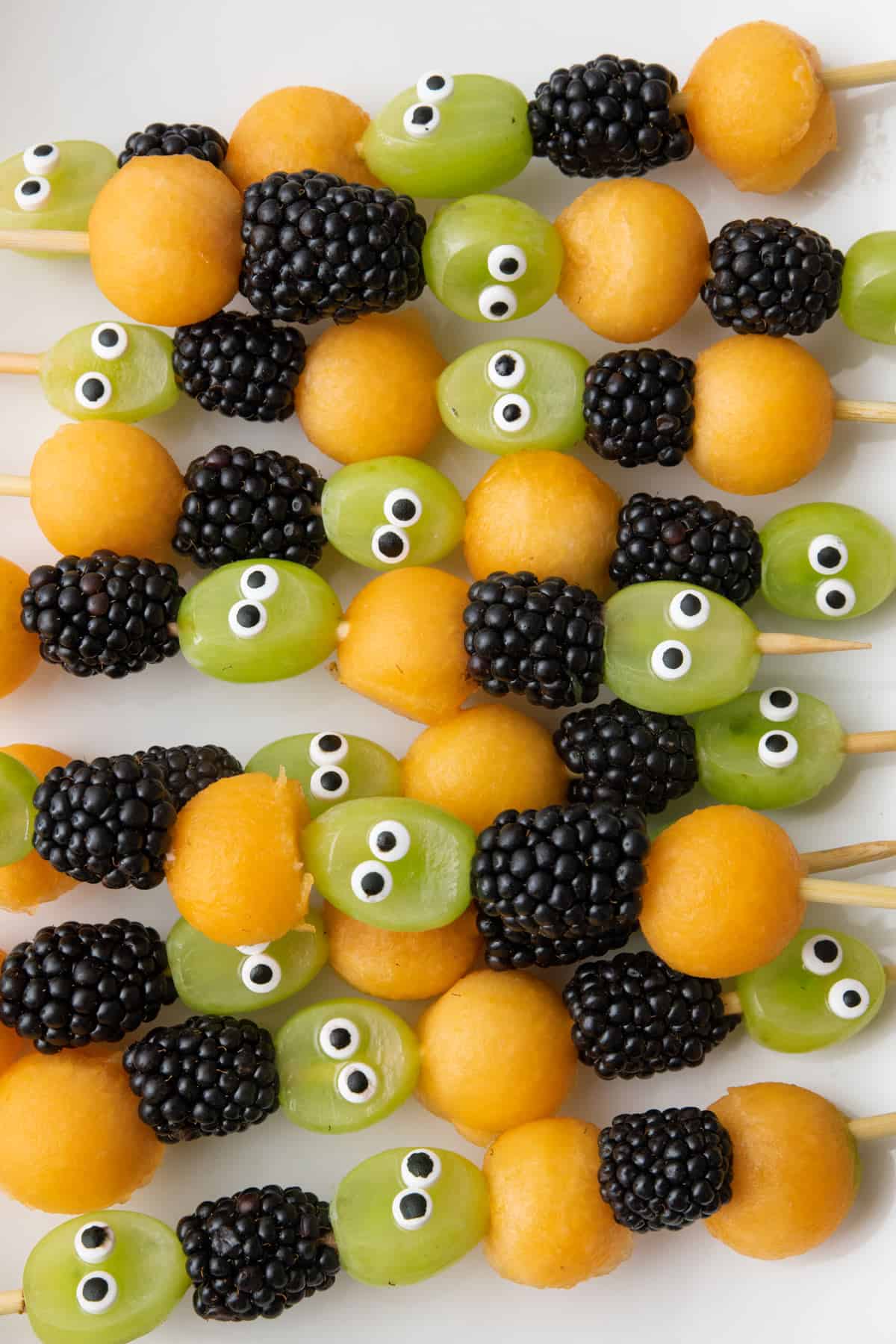 Halloween cake with candy eyes decoration on wooden table. Close up Stock  Photo