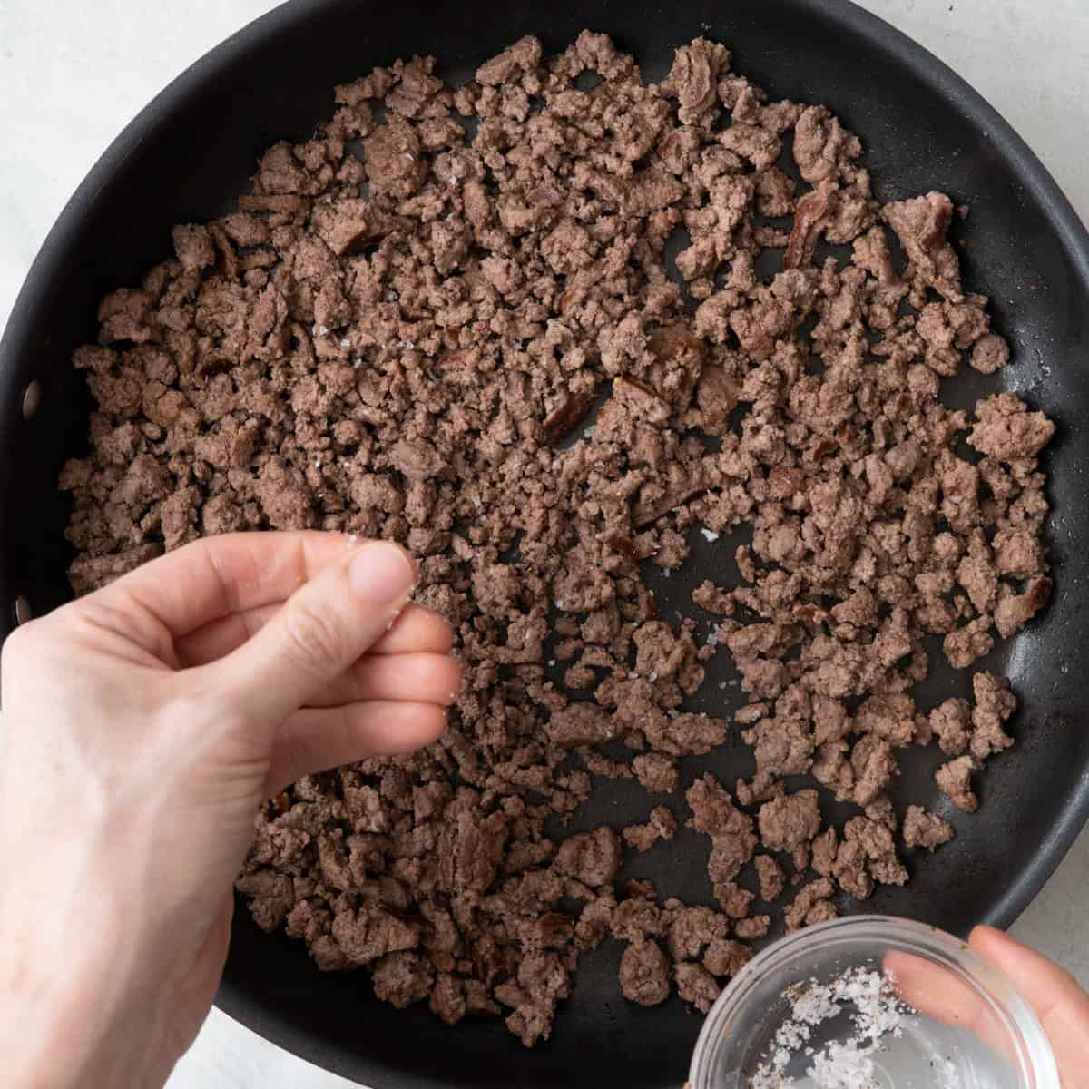 Adding salt or pepper.