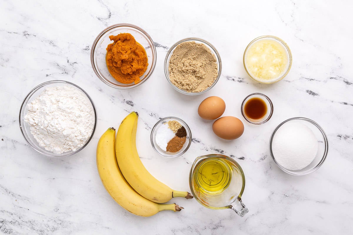 Ingredients for recipe: flour, pumpkin, brown sugar, spices, bananas, oil, eggs, melted butter, vanilla, and sugar.