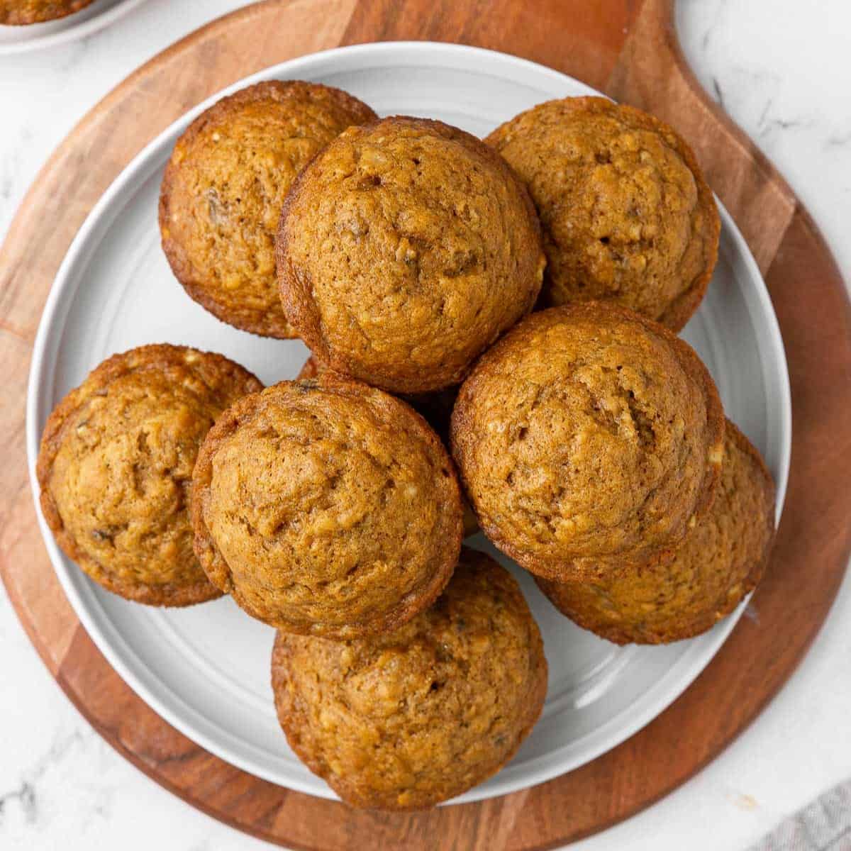 Pumpkin banana muffins on a plate.