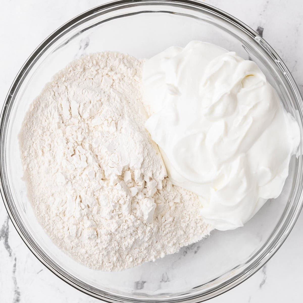 Greek yogurt and flour in a bowl.