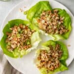 3 chicken lettuce cups on a plate.