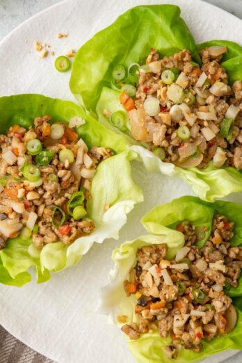 3 chicken lettuce cups on a plate.