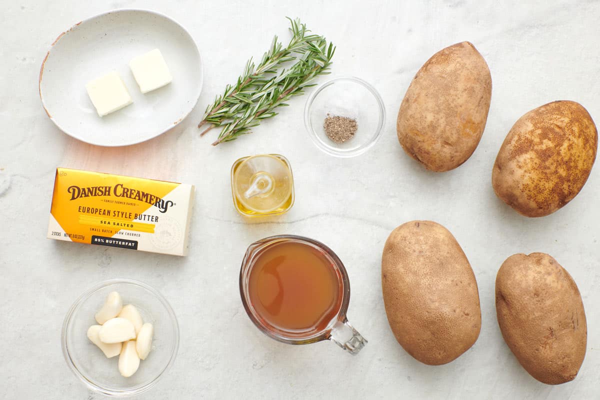 Ingredients for recipe: Danish Creamery European Salted Butter, rosemary sprigs, oil, salt and pepper, garlic cloves, broth, and 4 whole potatoes.