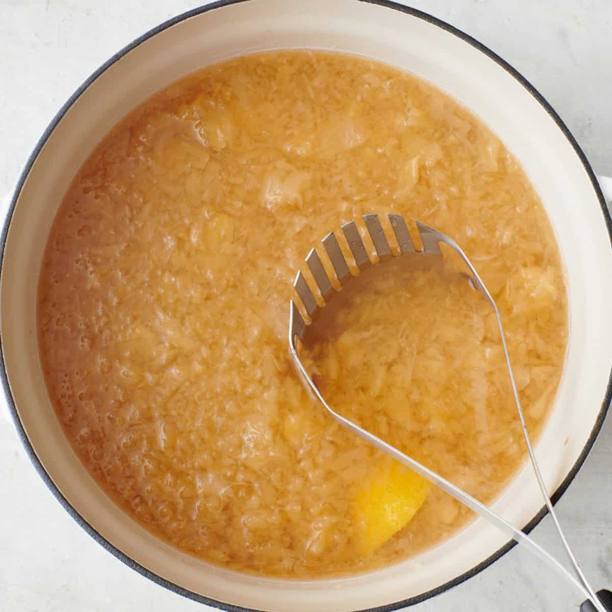 Mashing with potato masher in pot after simmering for an hour.