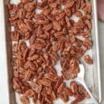 Candied pecans on baking sheet.