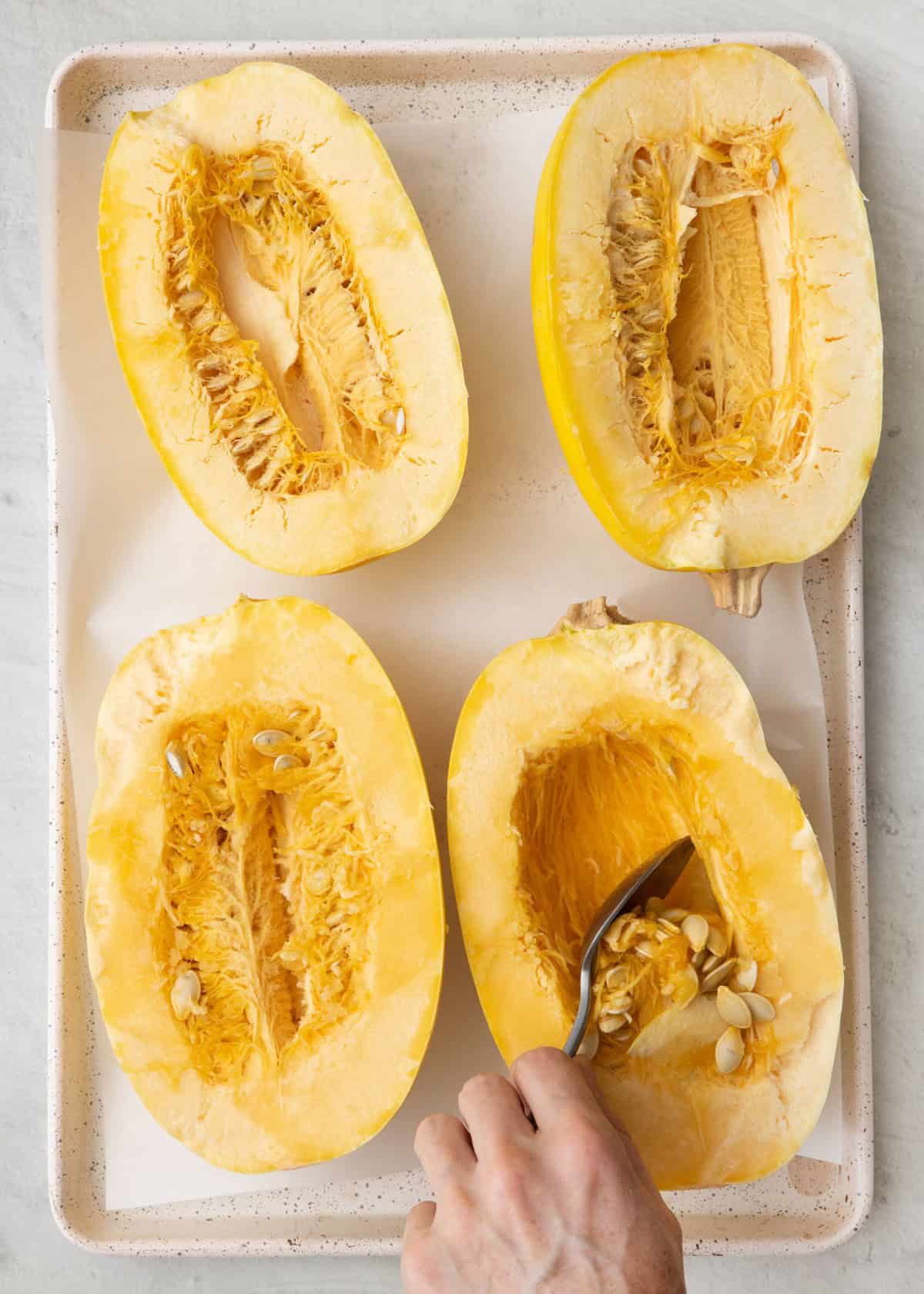 Scooping squash insides out.