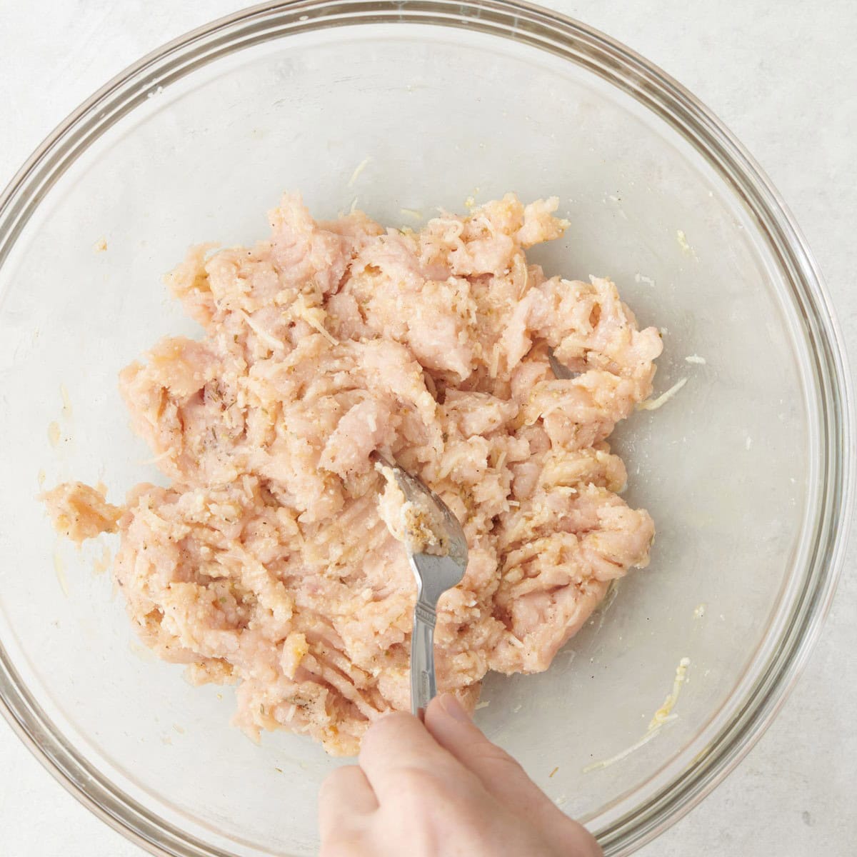 Mixing ingredients together with a fork.