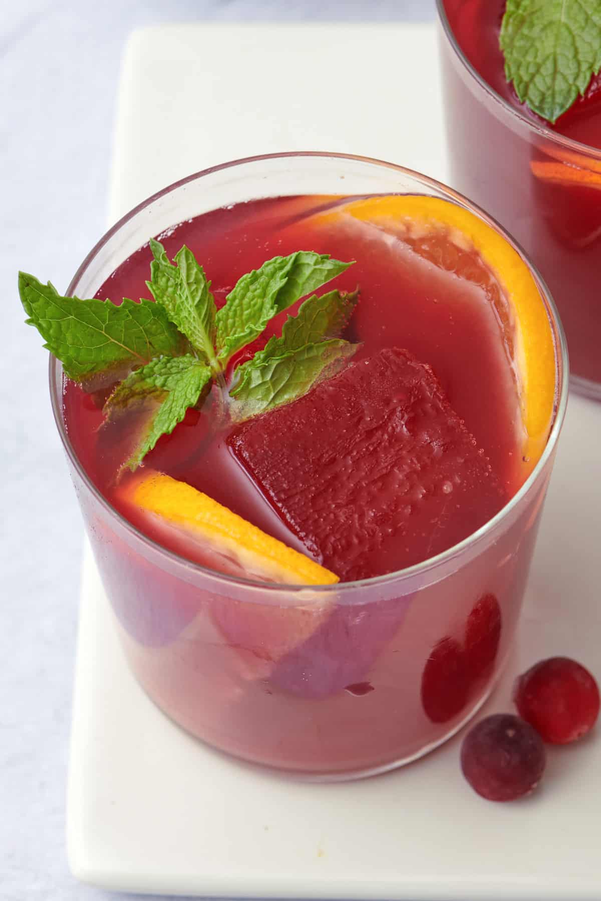 Top down look into a glass of cranberry orange mocktail.