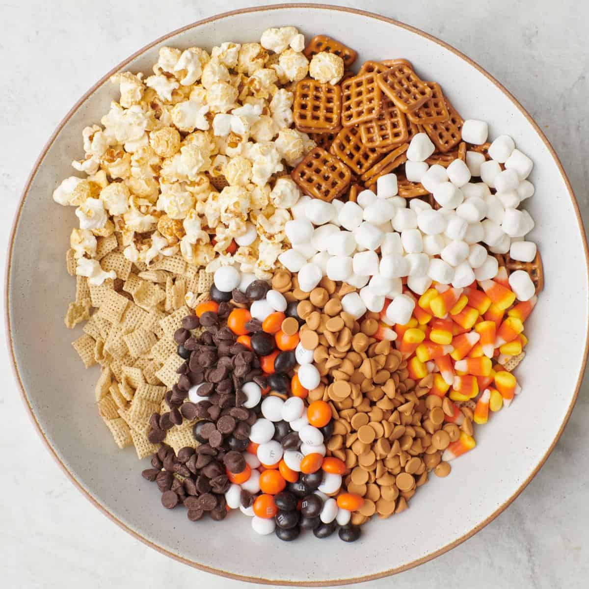 Ingredients in a large shallow mixing bowl, separated into sections before combining.
