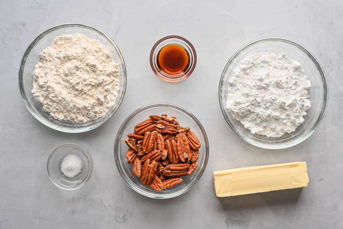 Ingredients for recipe: flour, salt, vanilla, pecans, powdered sugar, and butter.