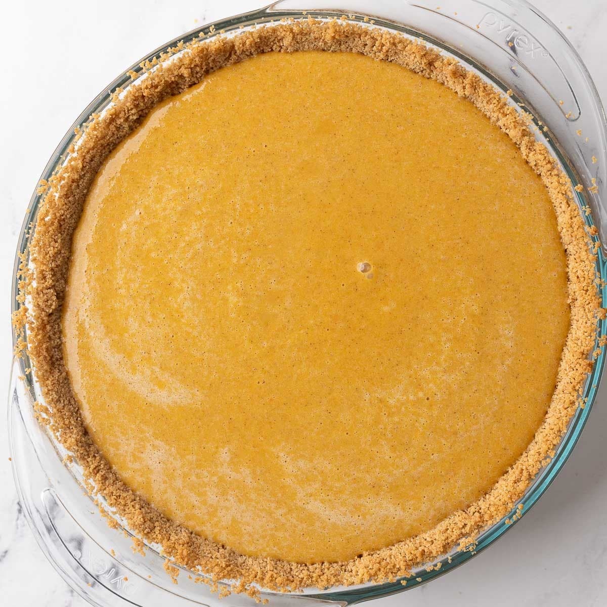 Filling transferred to the prepared pie crust before baking.