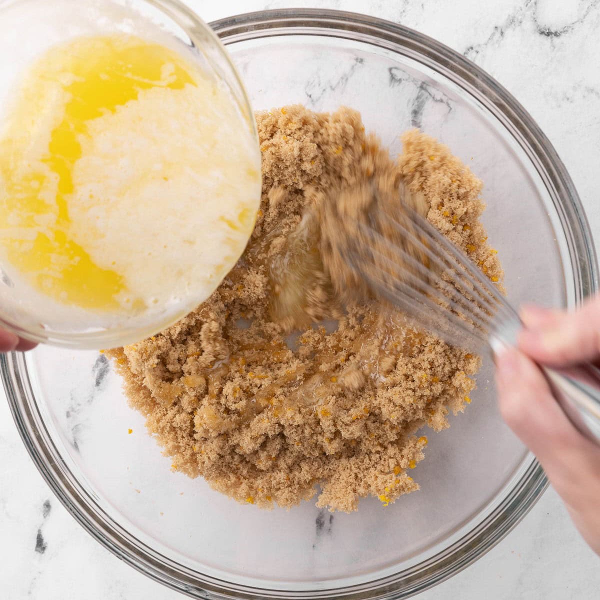 Whisking in melted butter.