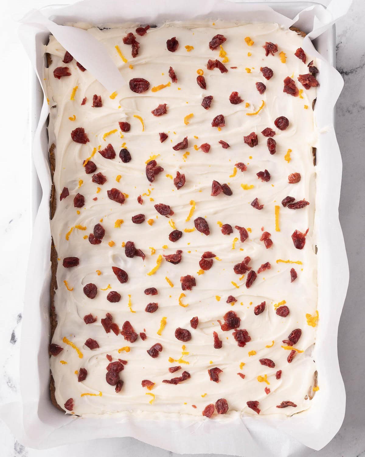 Chopped dried cranberries and zest sprinkled on top.