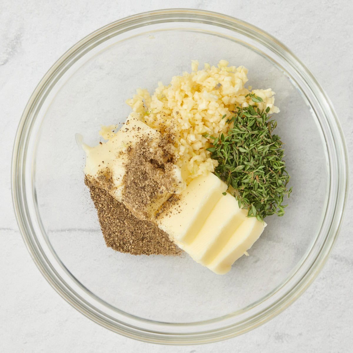 Softened butter, garlic, thyme and pepper in a small bowl before combining.