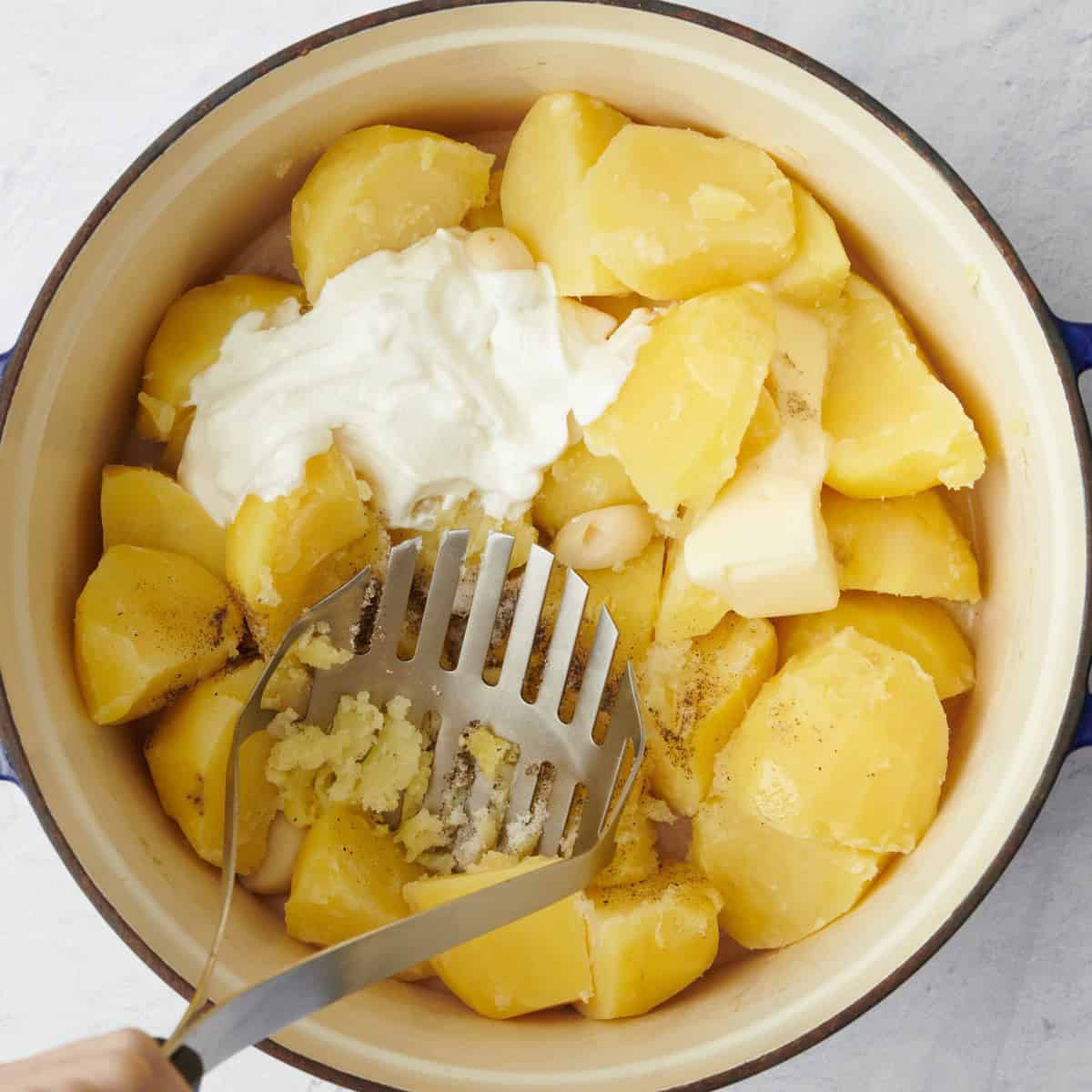 Mashing with a potato masher.