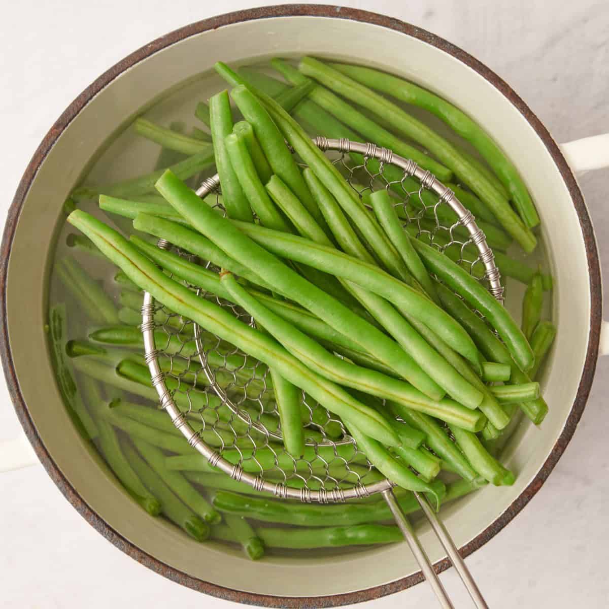 Removing green beans from pot.