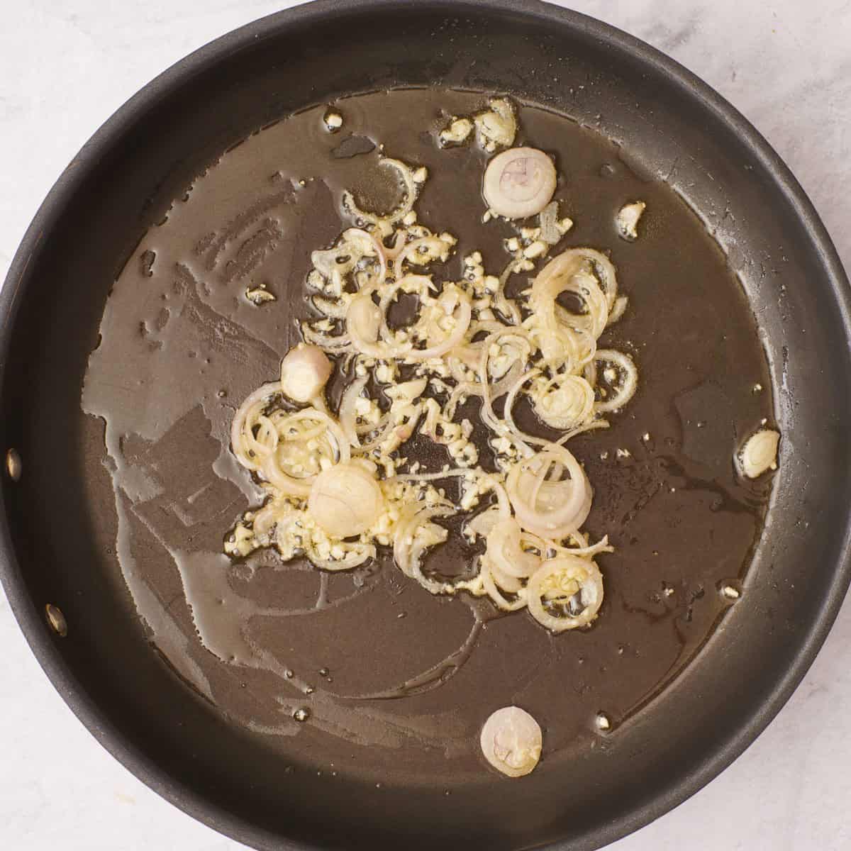 Shallots and garlic in pan.