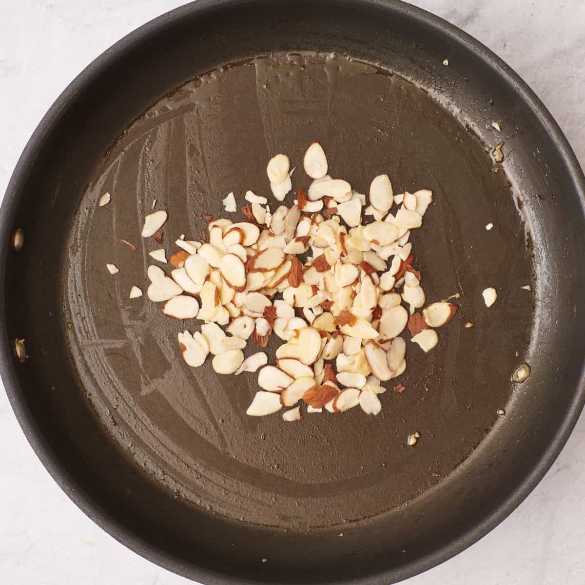Almonds toasting in pot.