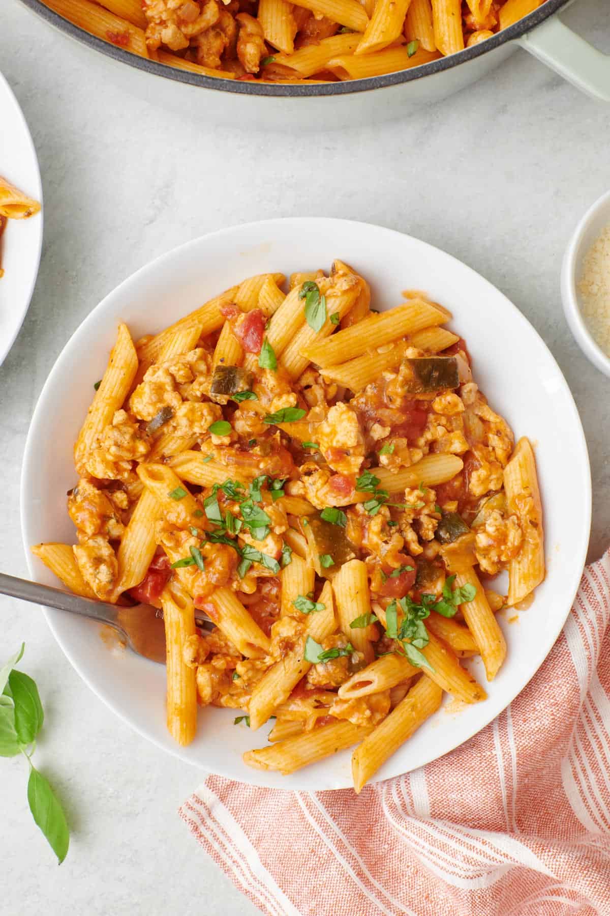 One pot turkey pasta on a plate with the pot nearby.