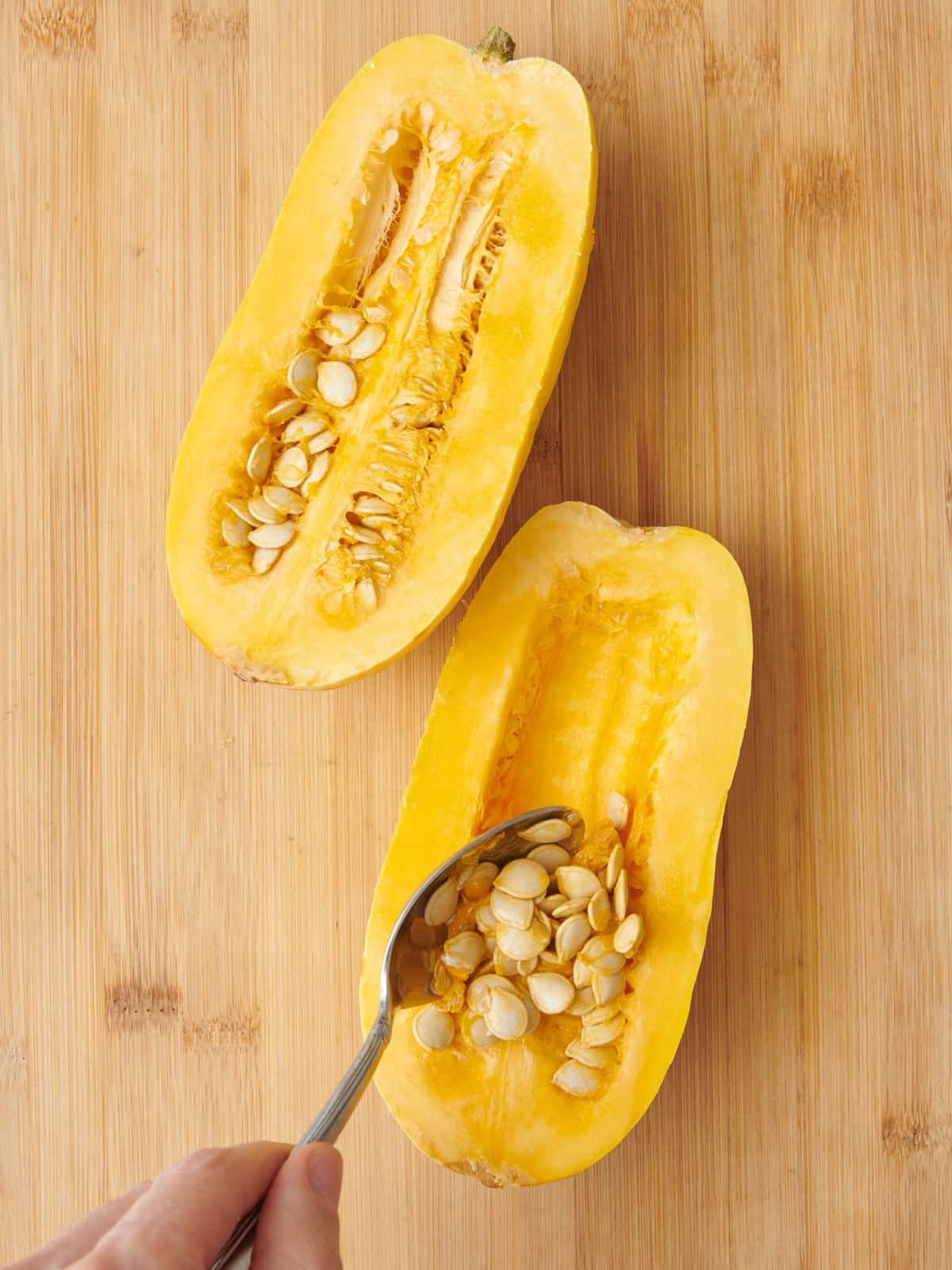 Spoon scooping out seeds.