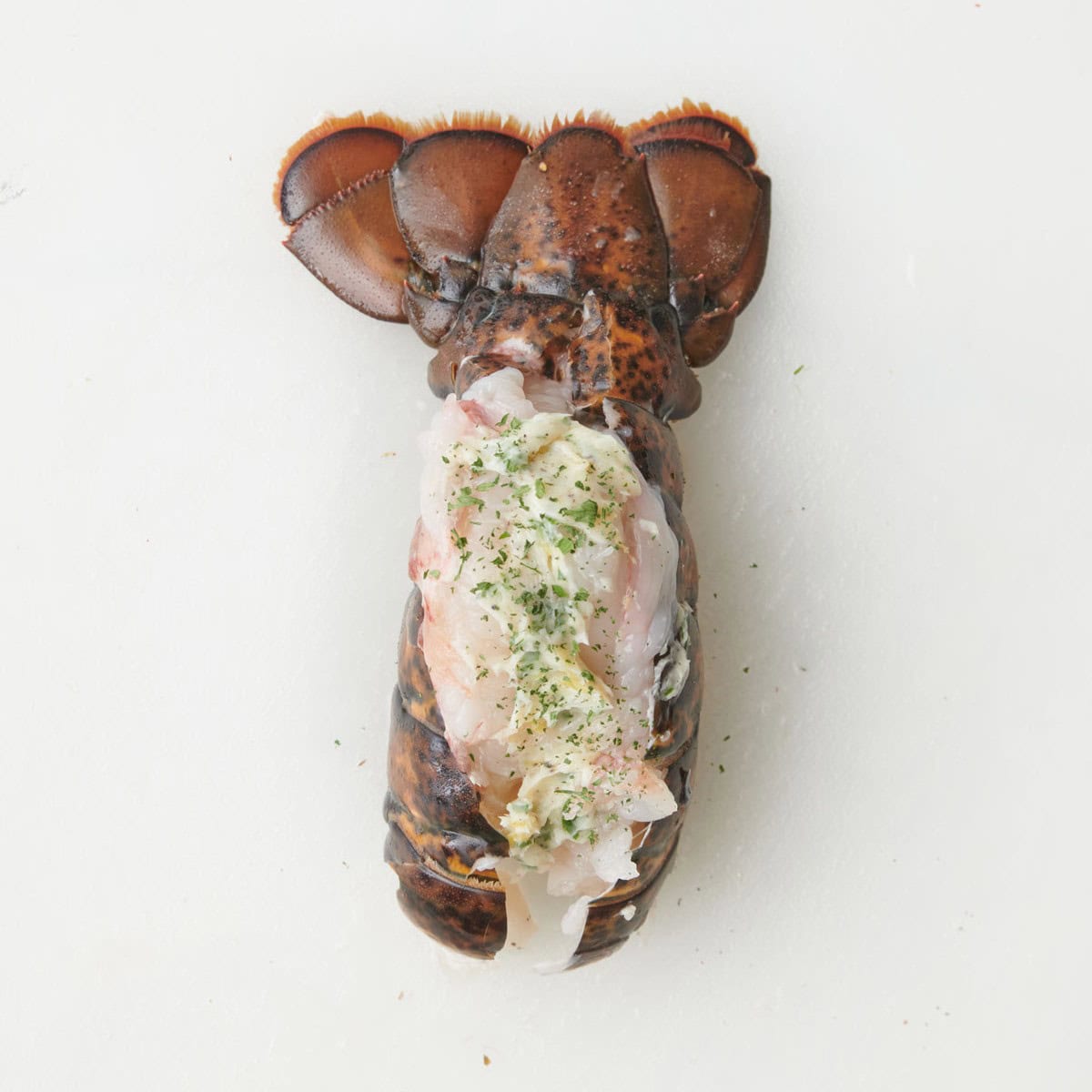 Meat resting on top of shell with butter added.