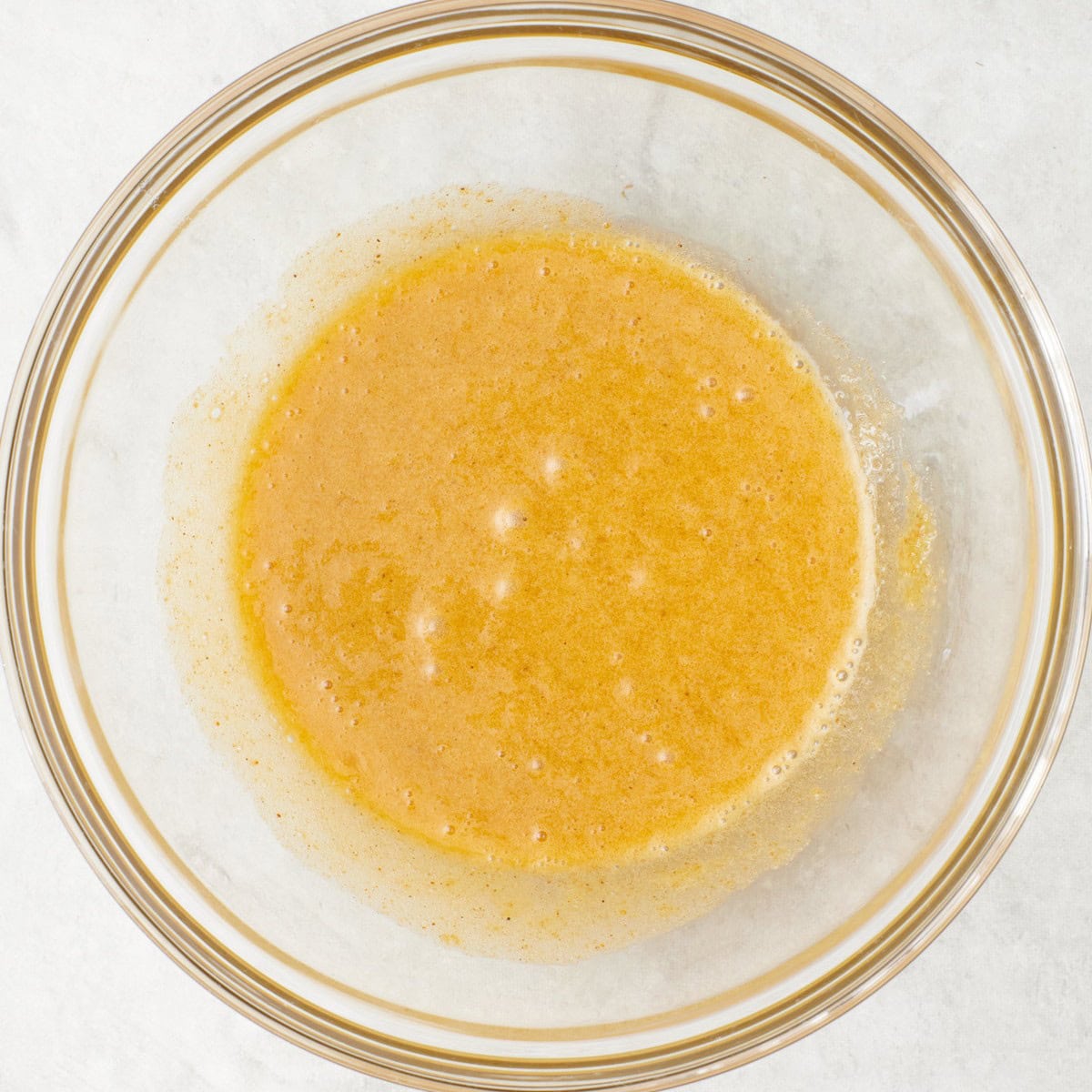 After whisking with sugar is mostly dissolved.