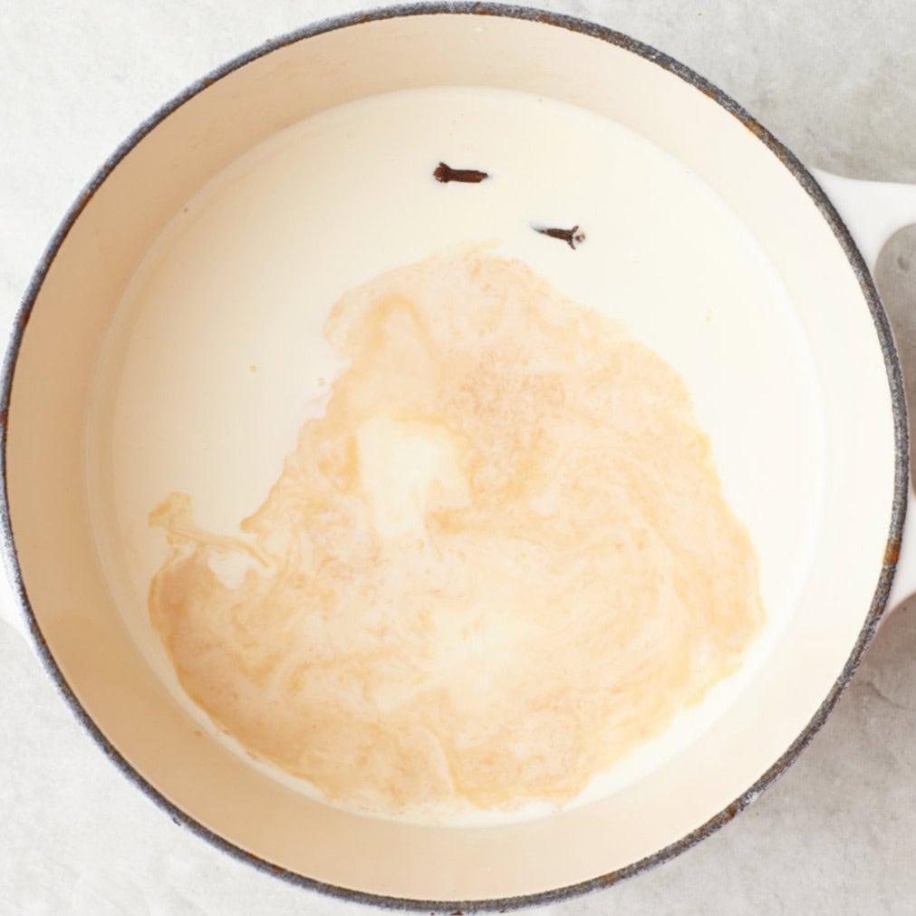 Milk, cream, vanilla, and cloves in a medium saucepan.