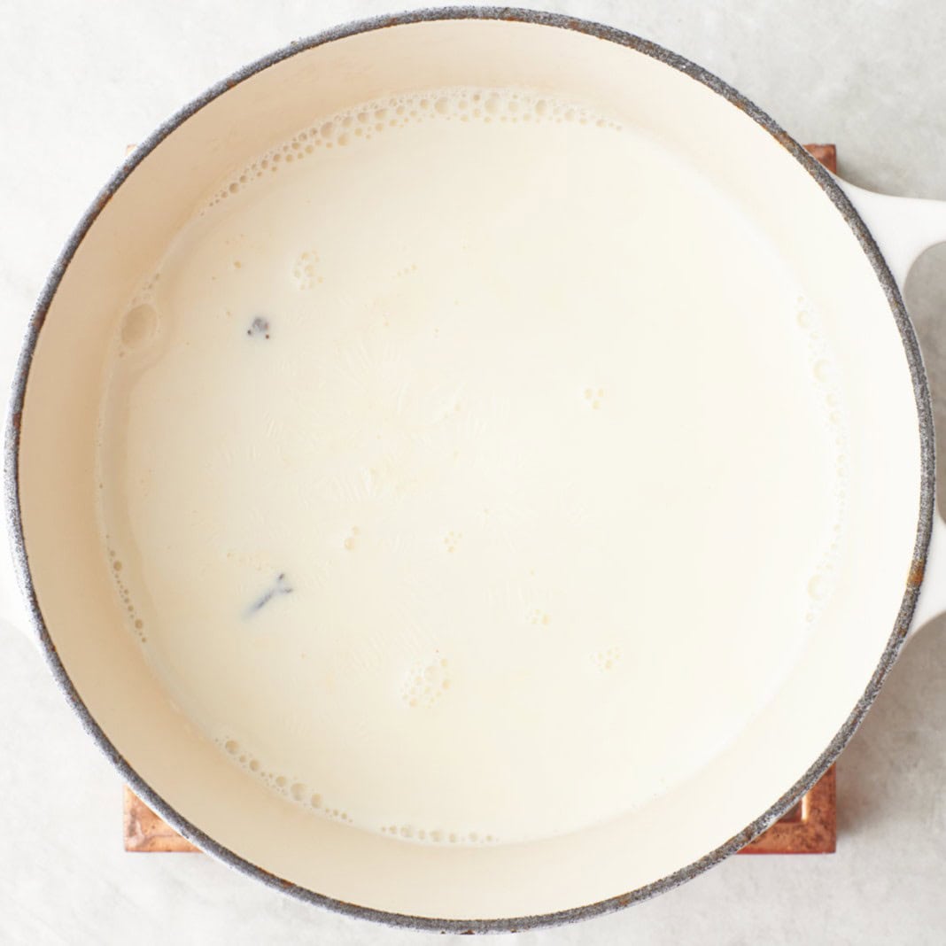 Milk mixture after simmering with bubbles around the side of the pan.