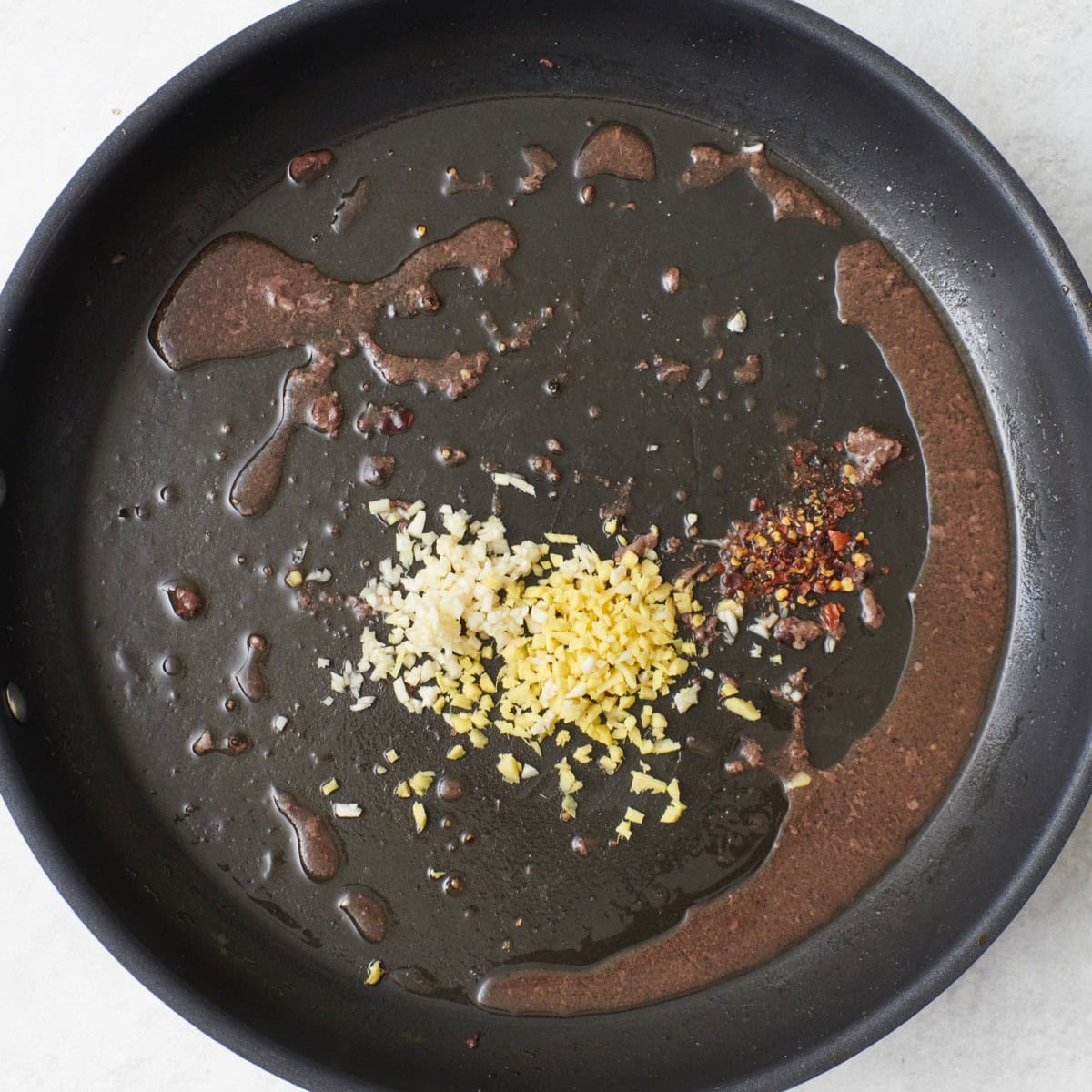 Beef removed with garlic, ginger, and red pepper flakes added.