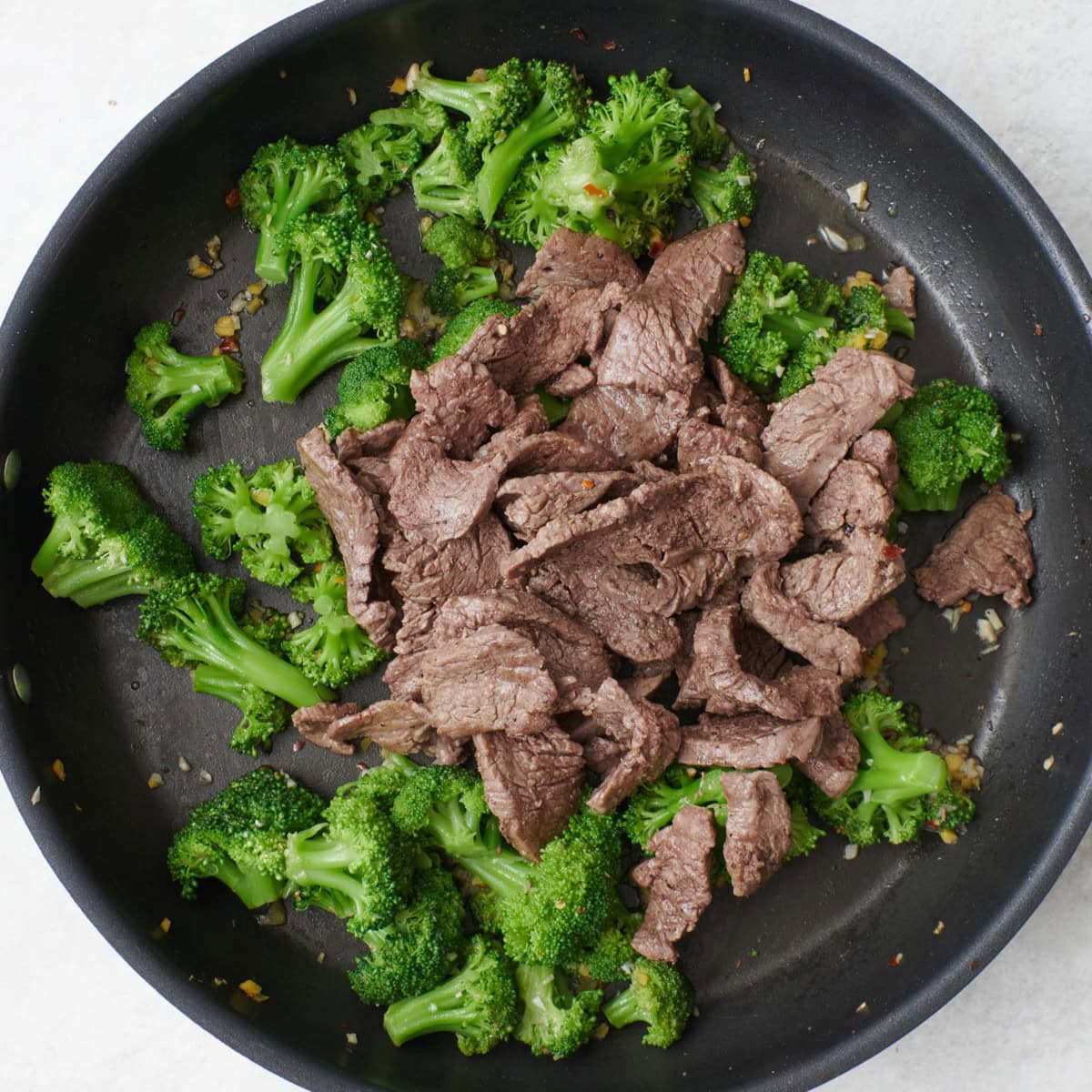After frying with beef added back and sauce being poured over.
