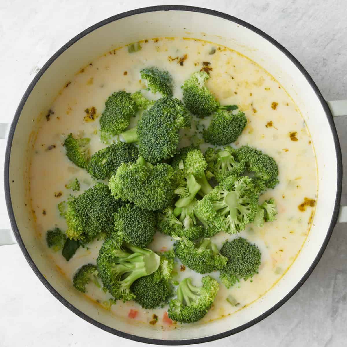 After veggies have softened with garlic, oregano, and nutmeg added. Chicken broth and milk after bringing to a boil with broccoli added.