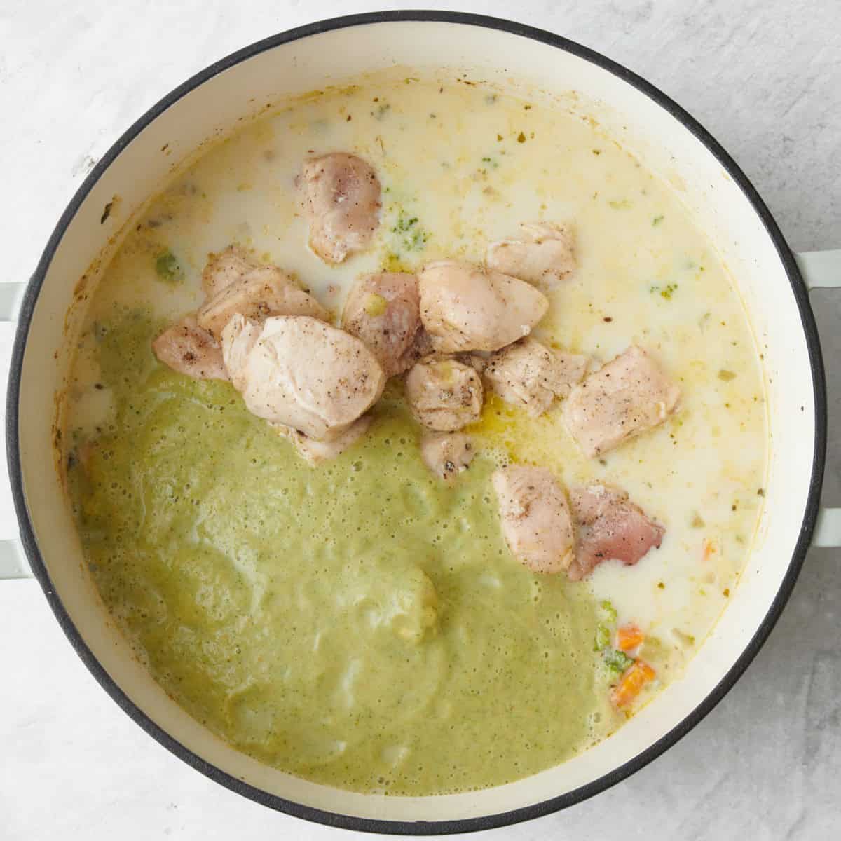 Blended mixture added on top and reserved chicken back to pot.