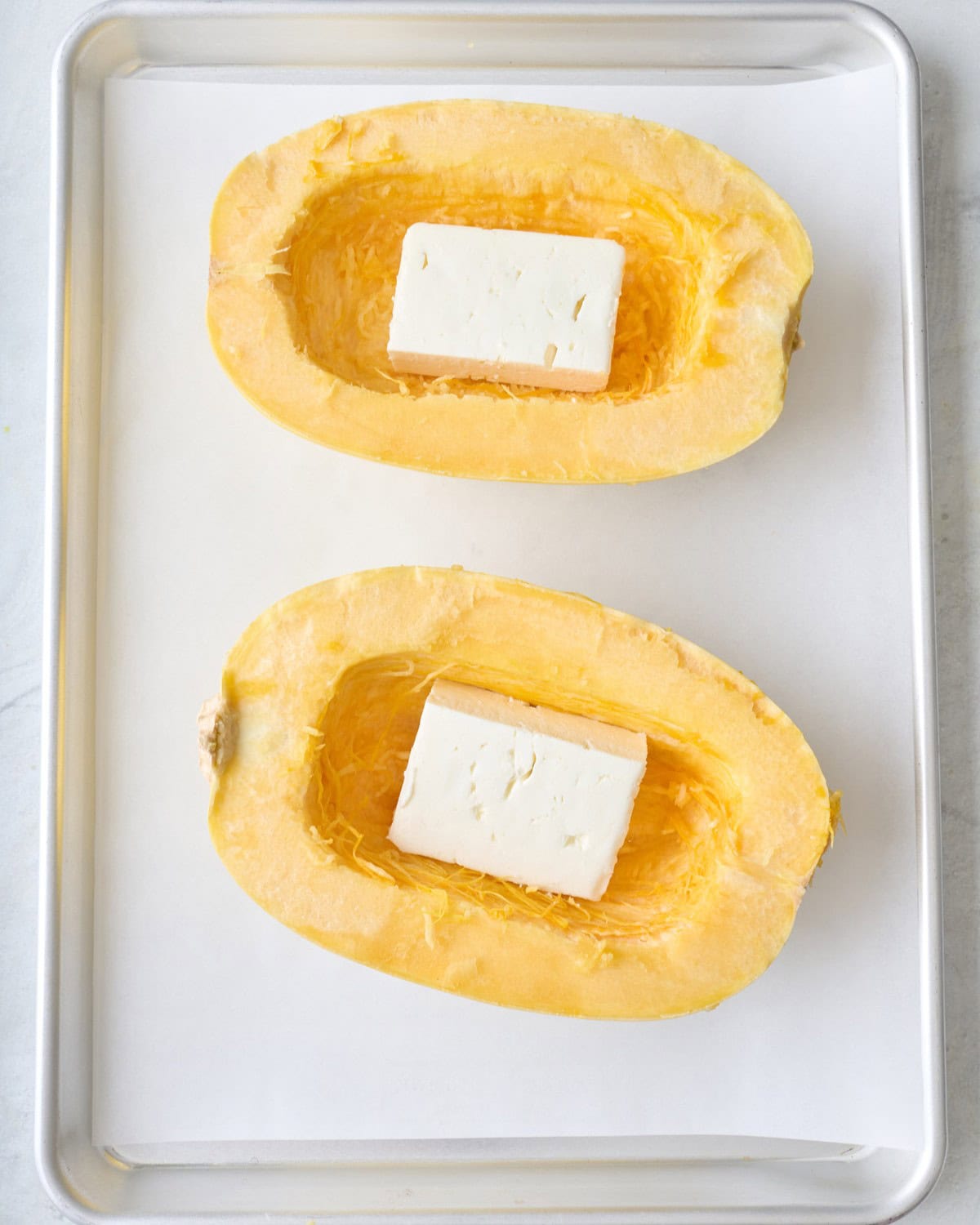 Feta cheese added to each spaghetti squash.