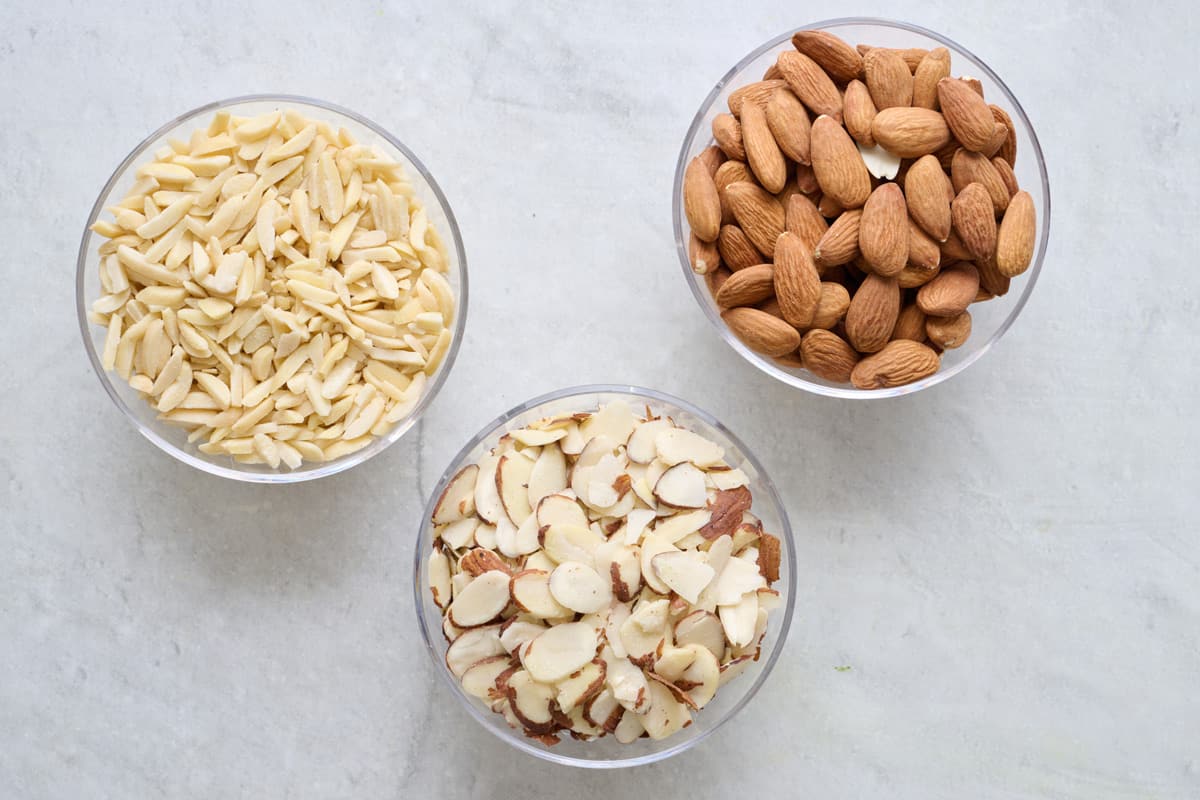 3 bowls of different types of almonds: slivered, sliced, and whole.