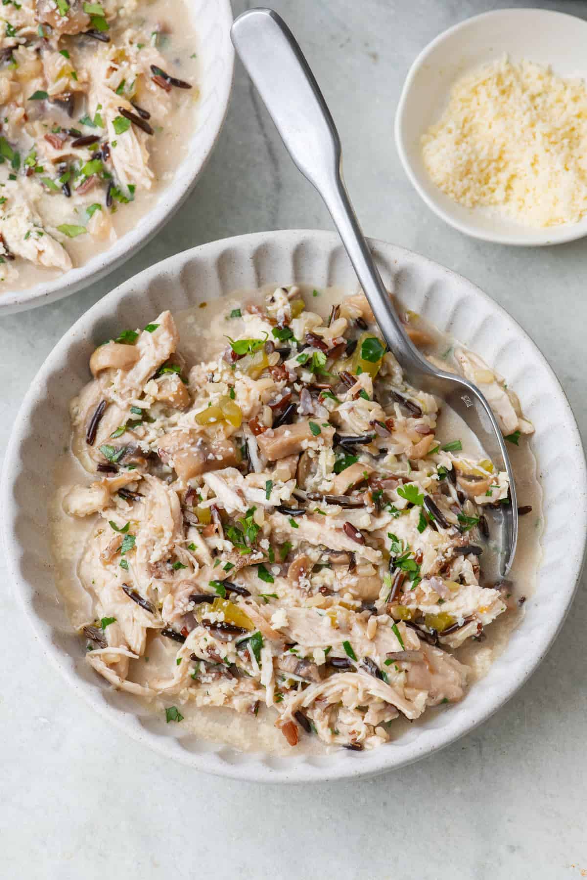 Two bowls of Instant pot chicken and wild rice with focus on one.