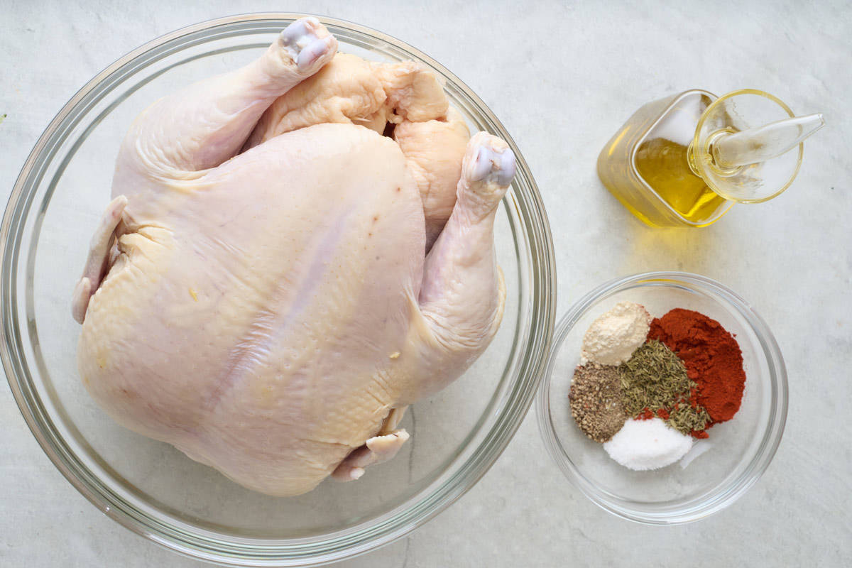 Ingredients for recipe: Whole chicken, olive oil, paprika, dried thyme, garlic powder, salt, and black pepper.