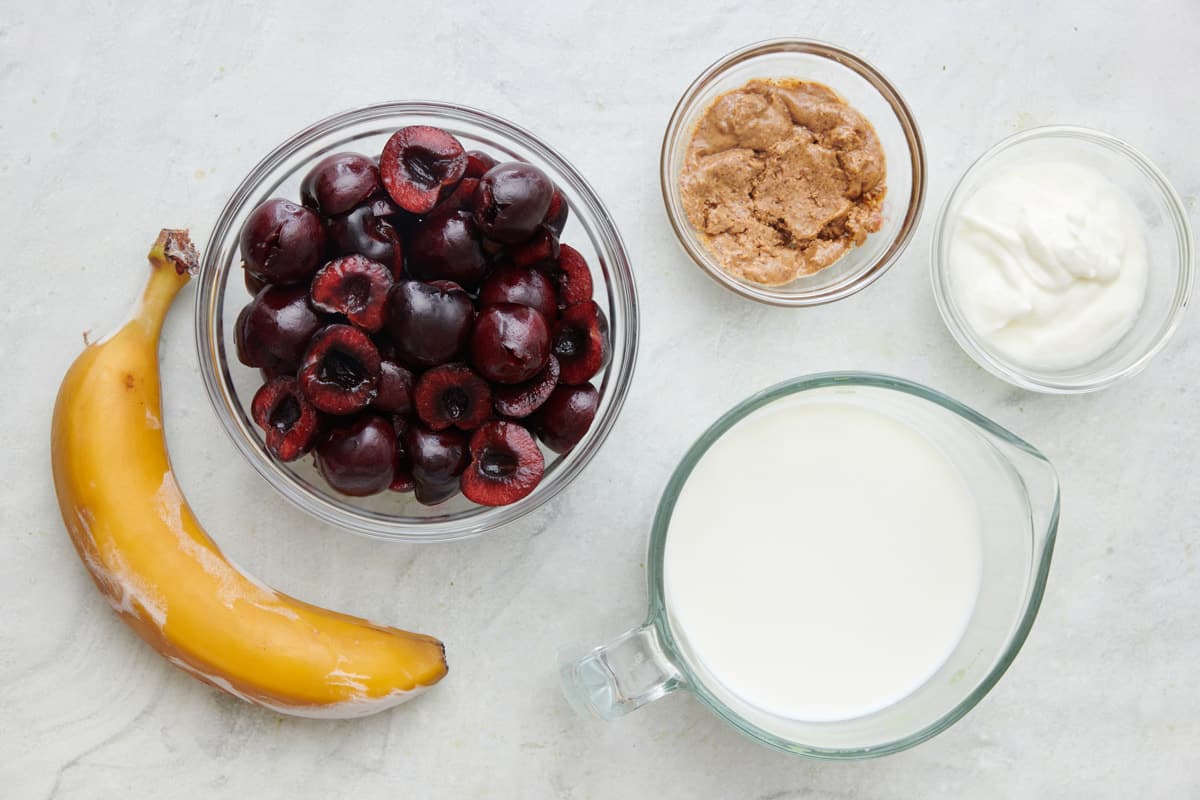 Ingredients for the recipe: Frozen banana, cherries, Greek yogurt, almond butter, and almond milk.