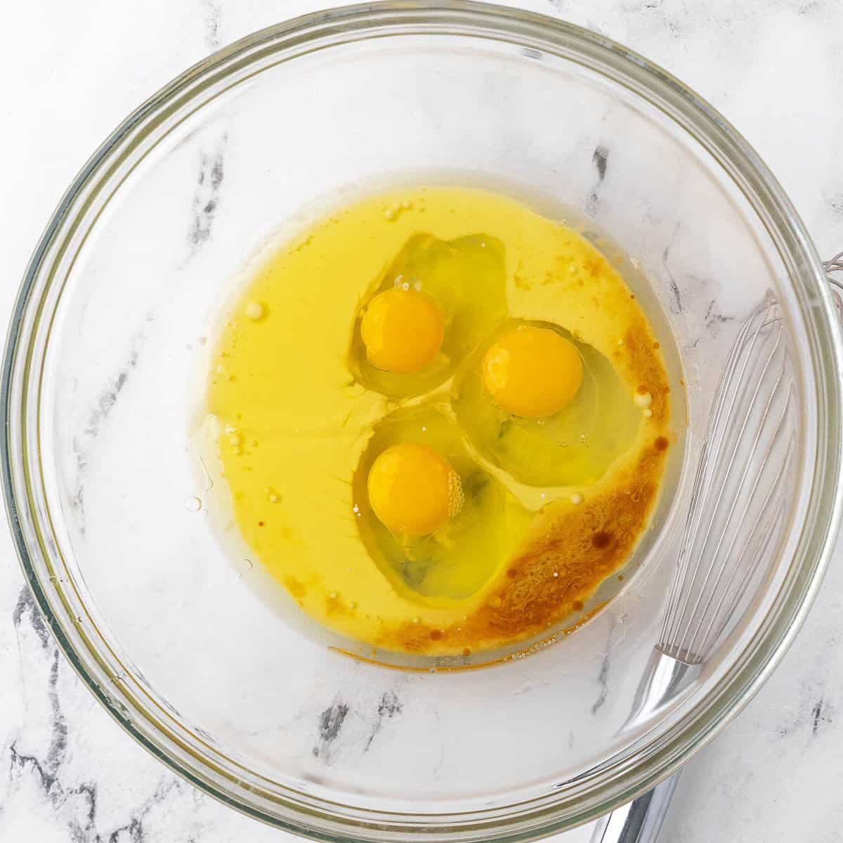 Oil, milk, eggs, and vanilla in a bowl before mixing.