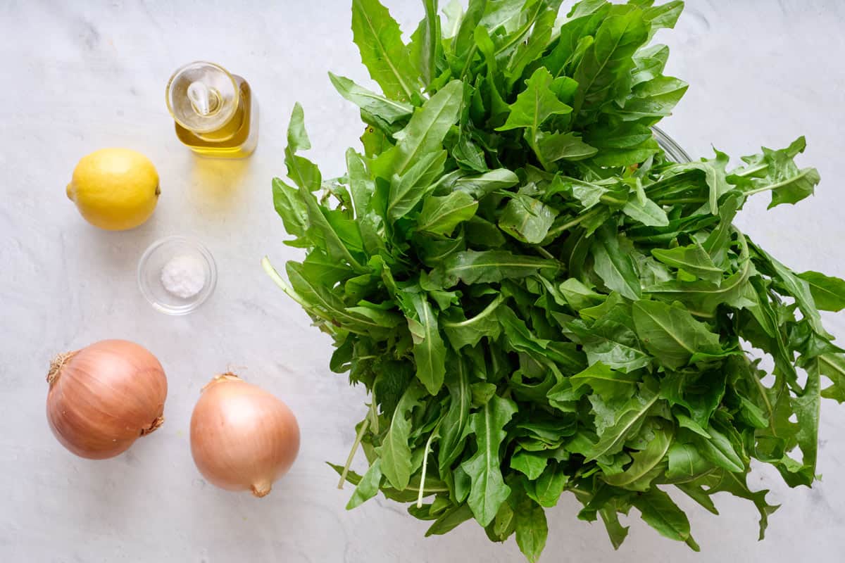 Ingredients for recipe: dandelion greens, onions, lemon, salt, and oil.