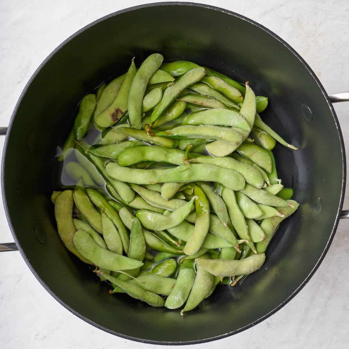 Edamame in a pot of water.